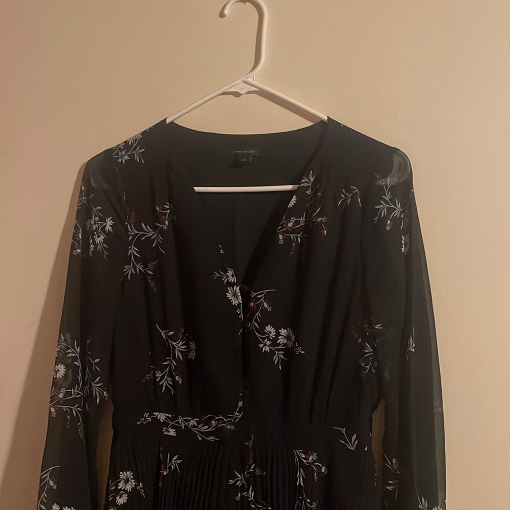 It is a black dress with flower prints
